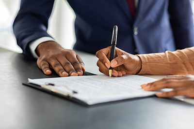 Bank customer signing documents.